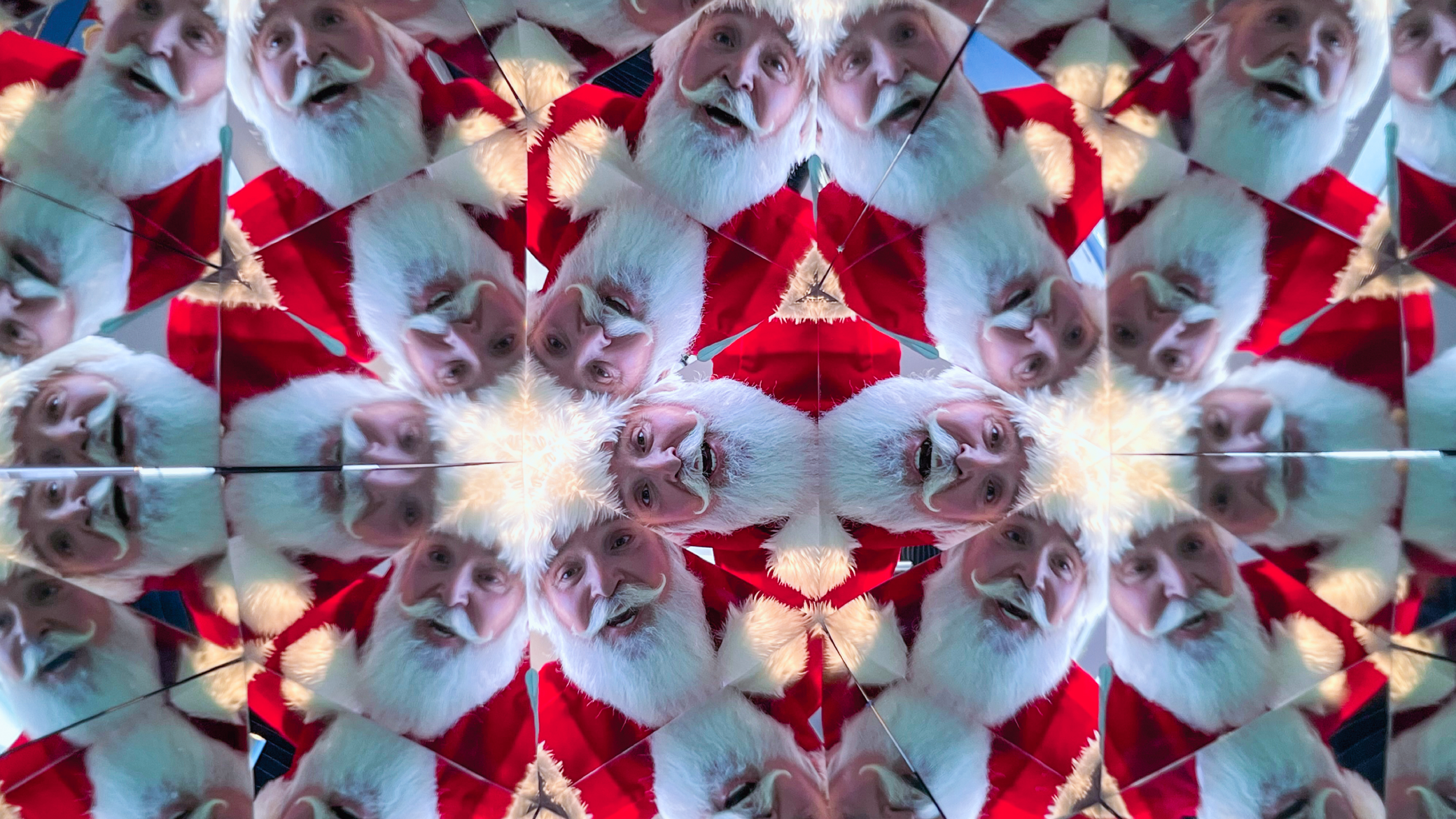 Santa Claus's head is reflected in a pattern of the Kaleidoscope exhibit at Museum of Illusions Atlanta.