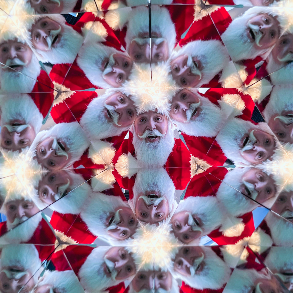 Santa Claus is reflected in a kaleidoscopic pattern at Museum of Illusions Atlanta.